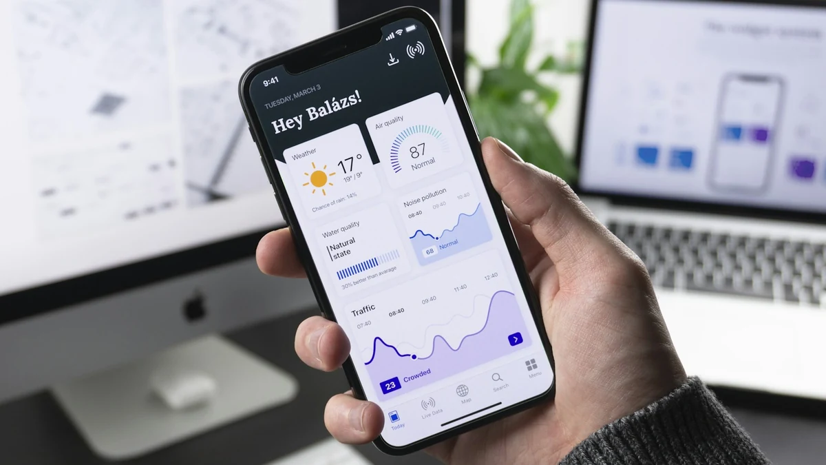 Software engineer testing progressive web app and native mobile interfaces
